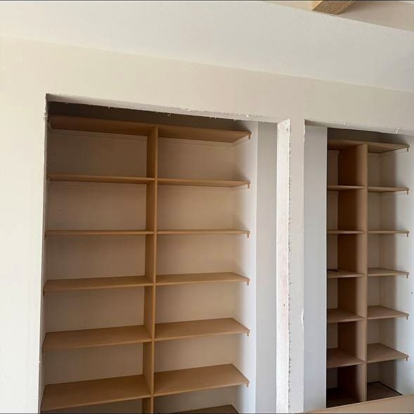 Built-in alcove bookshelves before paint
