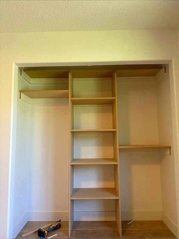 Custom reach-in closet organizer built into the wall