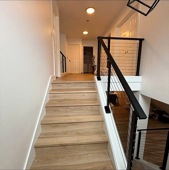Stair landing and hallway with cable railing