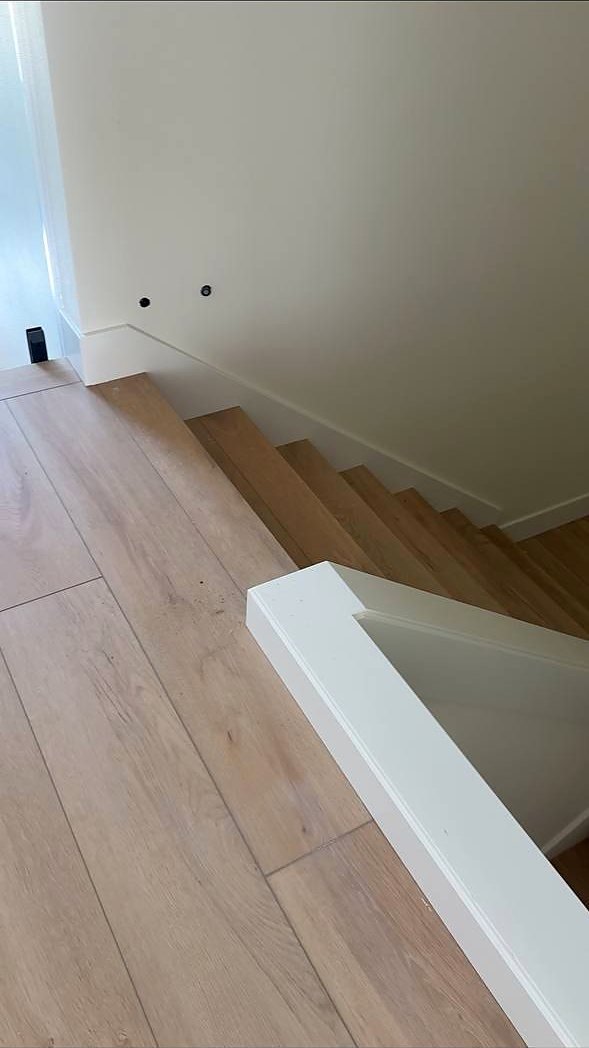 Skirt board scribed to the floor at the top of a stair